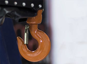 close up of orange lifting hook with safety latch