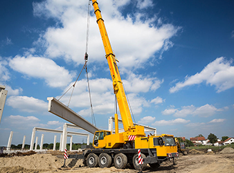 Mobile Crane Lifting Steel Beam At Construction Site mobile crane lifting steel beam at construction site