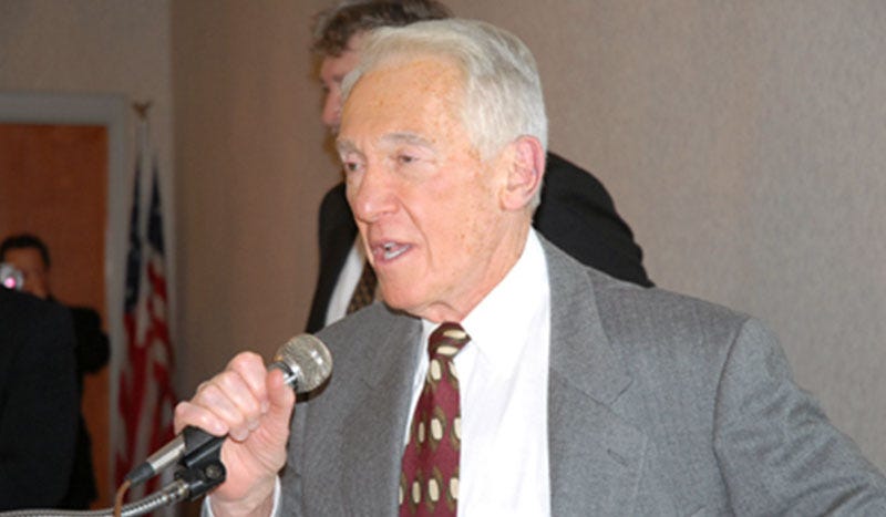 Marv Levy speaking into microphone