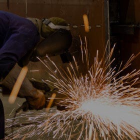 Person using a Grinder Wheel with Sparks person using grinder wheel
