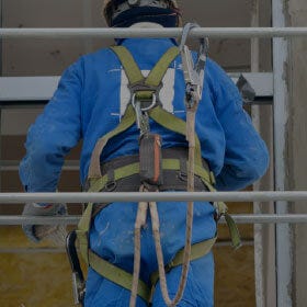 Man on Platform with Harness and Lifeline Attached man on platform with harness and lifeline attached